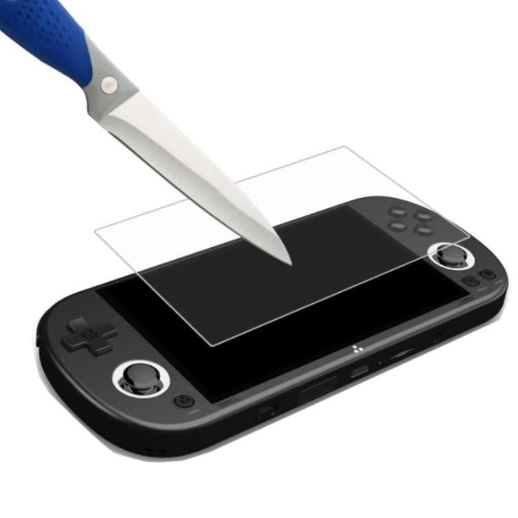 Tempered glass screen protector being applied with tool to handheld console screen