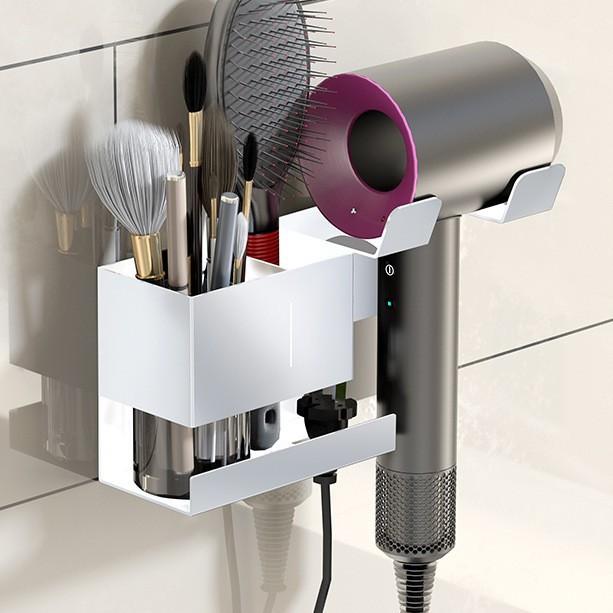 White wall-mount hair dryer holder with divided storage slots for styling tools.