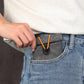 Gray drawstring pouch with snap toggle tucked into a jeans pocket