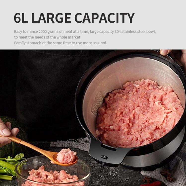 Large stainless steel grinding bowl filled with chopped meat, black rim base