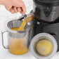 Stainless steel cone strainer filter above pitcher, perforated basket straining juice