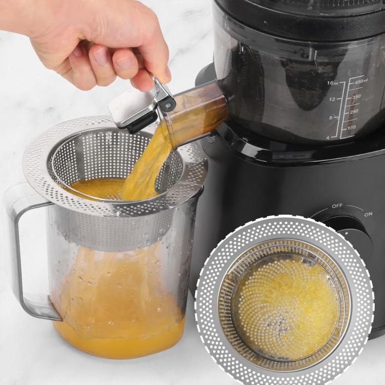 Stainless steel cone strainer filter above pitcher, perforated basket straining juice