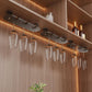 Under-cabinet hanging wine glass rack with clear stemware glasses and dark bar