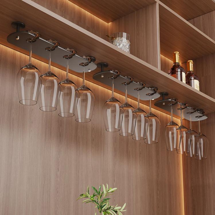 Under-cabinet hanging stemware rack with multiple clear wine glasses on metal row