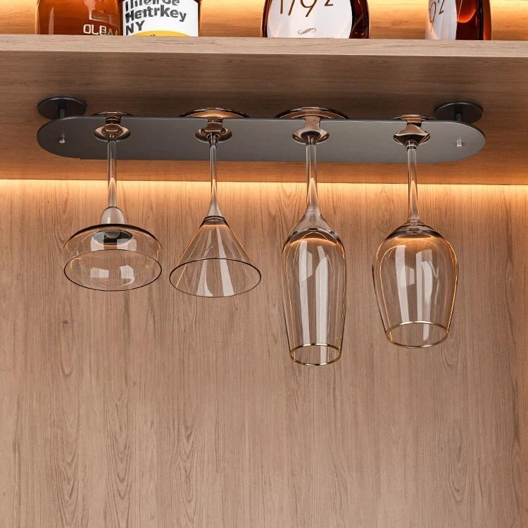 Under-cabinet champagne and wine glass holder with hanging clear glasses on metal bar