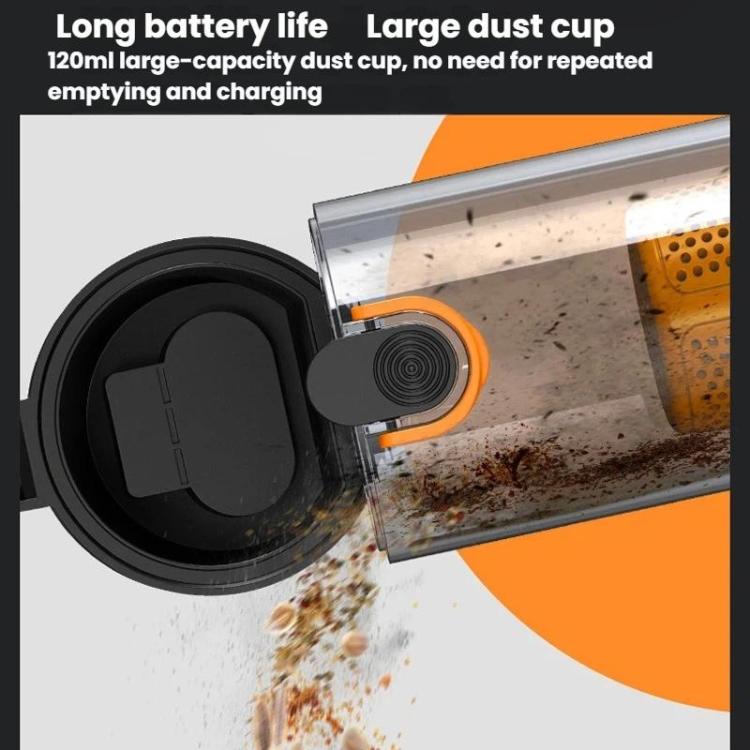 Vacuum cleaner dust cup area with orange filter and visible debris inside