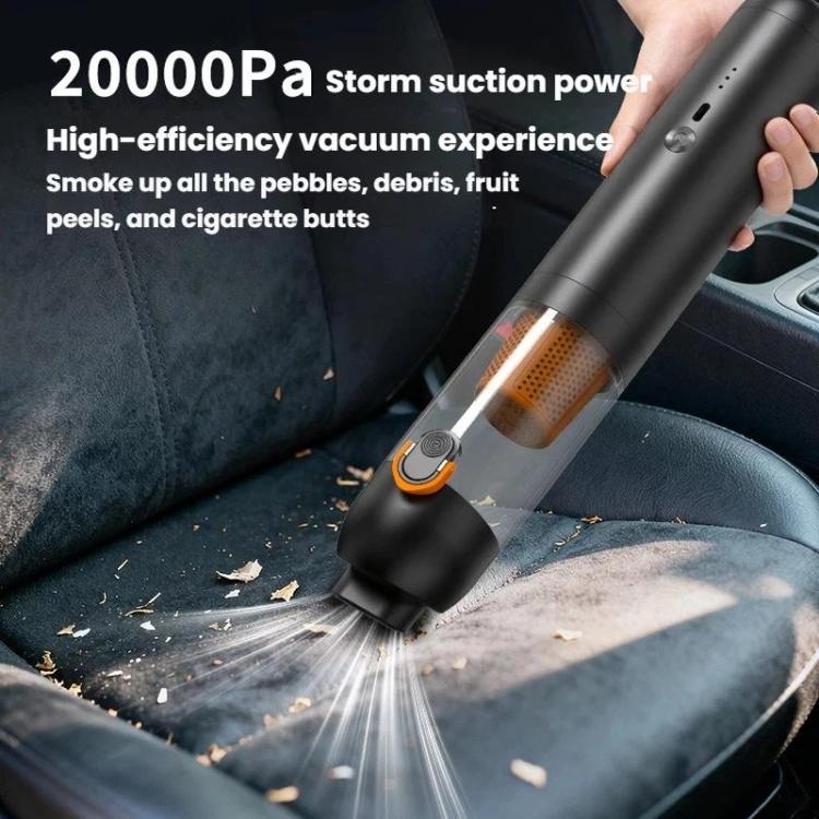 Black handheld cordless vacuum cleaner nozzle clearing debris on a car seat