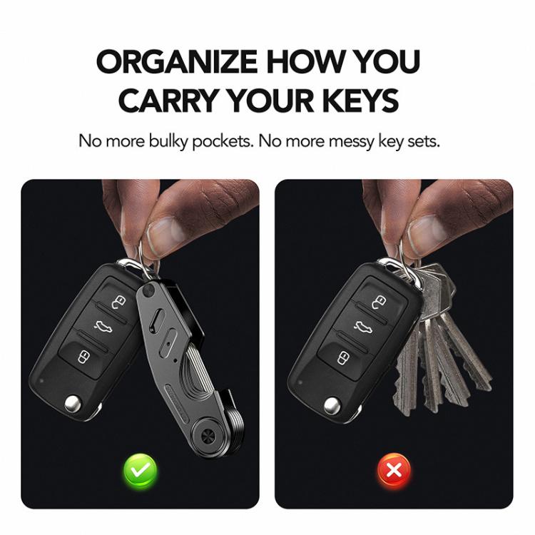 Black key organizer clip with key fob and car keys, held in a hand