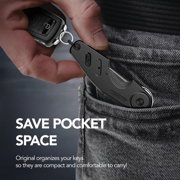 Black aluminum key holder clip attached to a key ring, hanging from jeans