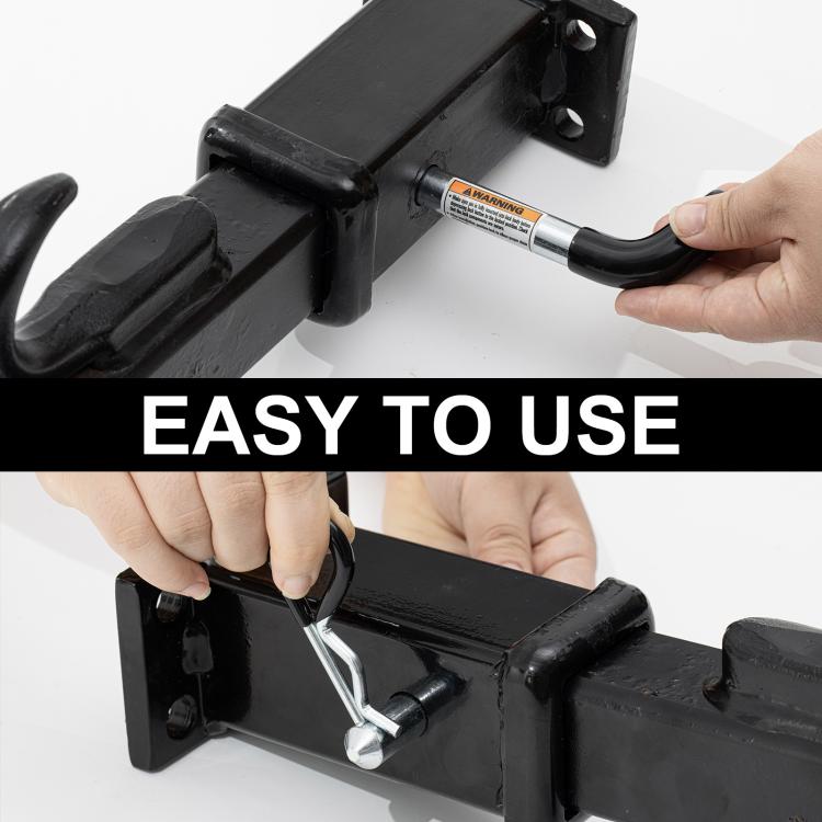 Trailer hitch pin inserted into hitch receiver, black grip held by hand