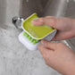 U-shaped scrub brush cleaning spoon under running water
