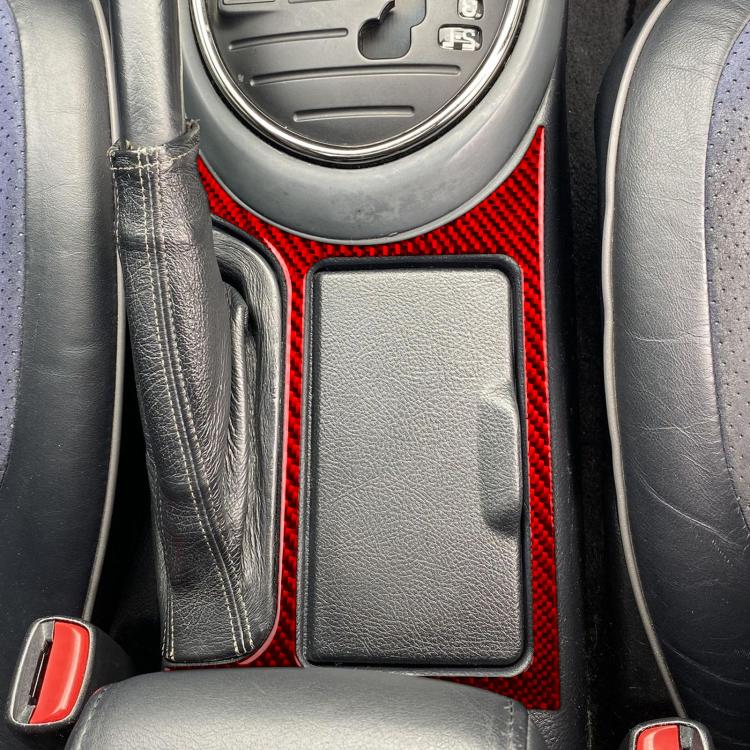 Red carbon-fiber cupholder frame sticker around rectangular insert in center console