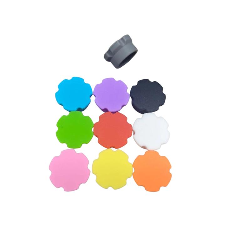 Assorted reusable insulin bottle caps in multiple colors: blue, purple, black, green, red, white