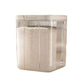 Transparent plastic cereal storage bucket with white press flip lid, filled with pale grains