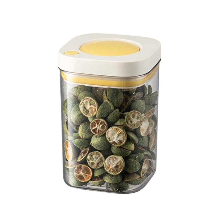 Vacuum food storage jar with yellow lid, clear body filled with green dried seeds