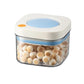 Vacuum food storage jar with blue lid, clear body filled with pale round beans