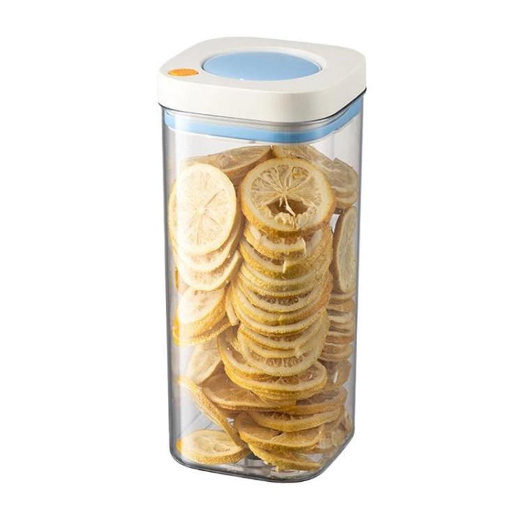 Vacuum food storage jar with blue lid, clear body filled with dried lemon slices