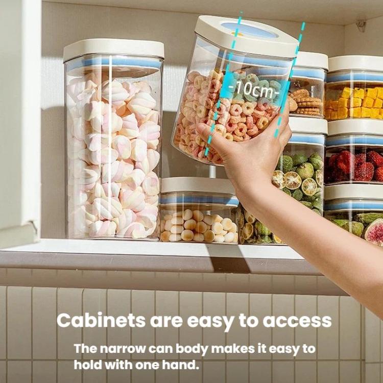 Vacuum food storage jars with blue lids in a cabinet, hand reaching to open one