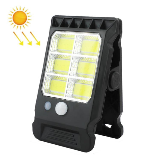 Black solar clip-on garden light glowing with warm LED panel