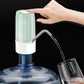 Mint green electric water dispenser with hands dispensing water into a cup
