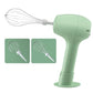 Green handheld electric egg whisk shown with two whisk attachments and stand base