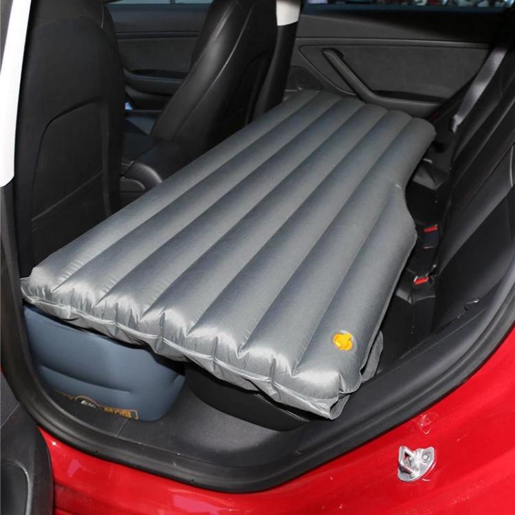 Gray fully inflated car rear seat air mattress with ribbed surface and edges