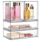 Transparent three-tier cosmetic organizer with open bins holding skincare bottles, creams, and a tray