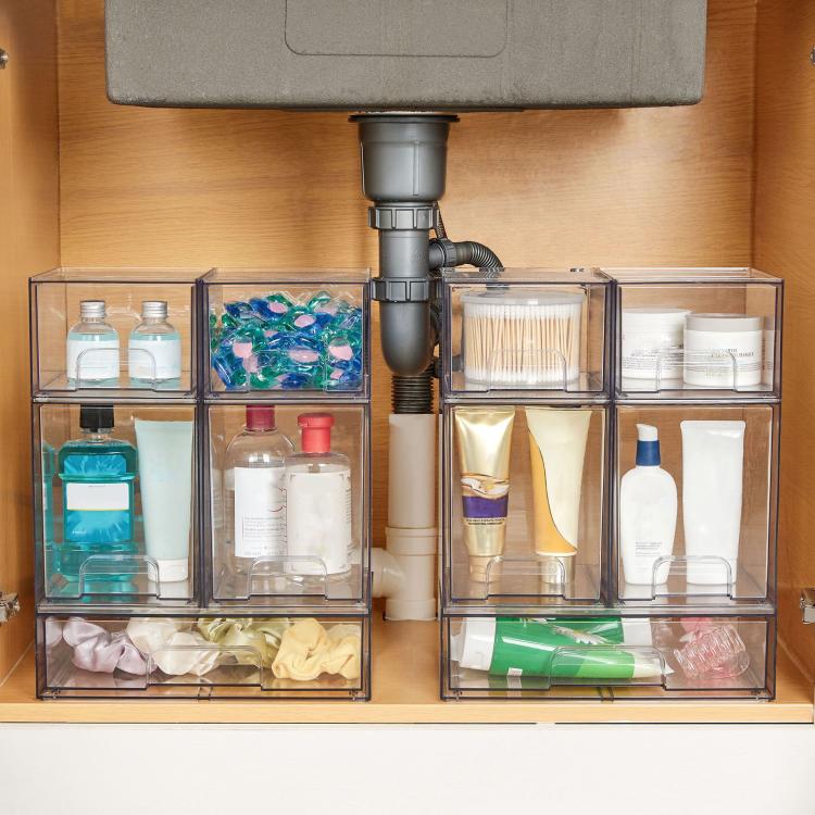 Clear plastic stackable cosmetic organizer bins with multiple small compartments