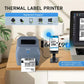 Gray thermal label printer on desk with connected label coming out