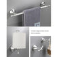Silver wall-mounted towel bar with textured towel and toilet paper holder