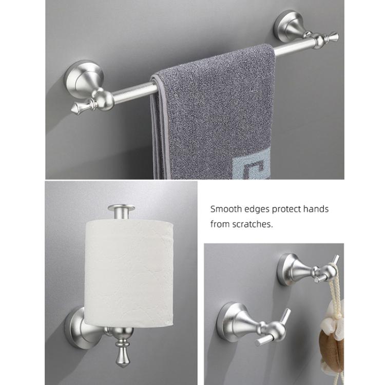 Silver wall-mounted towel bar with textured towel and toilet paper holder