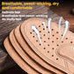 Stacked tan leather insoles with perforated tops and cushioned arch support