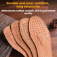 Set of tan leather insoles with stitched arch design and dotted ventilation holes