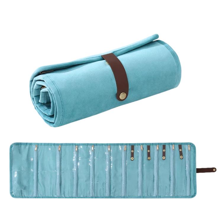 Light blue roll-up velvet jewelry organizer bag with brown strap and rows of pockets