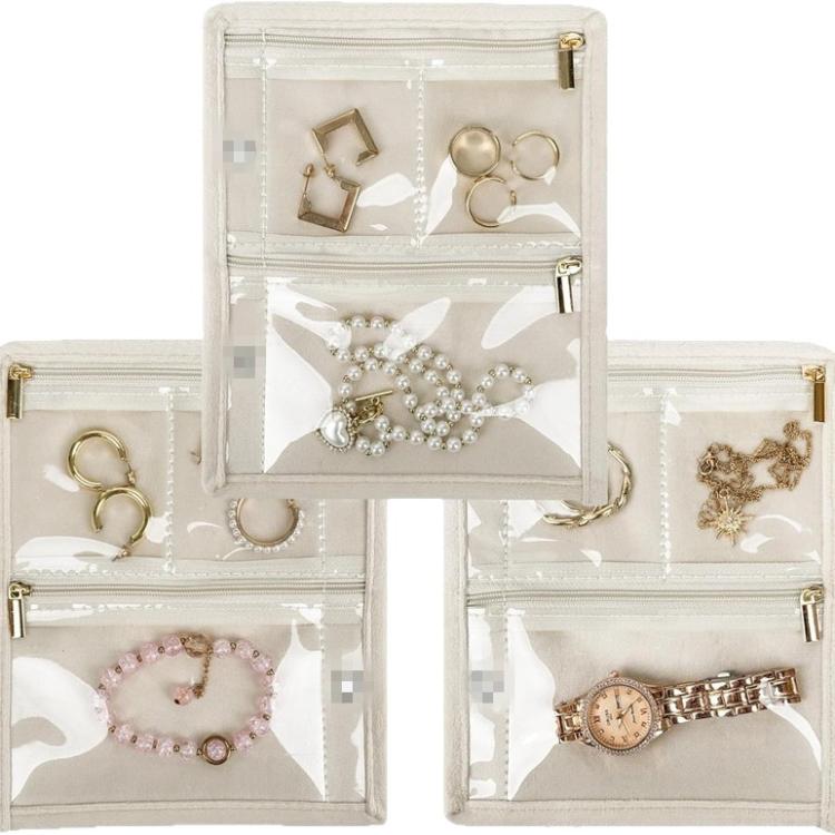 Jewelry organizer cases with transparent zip pockets holding rings, earrings, and necklaces