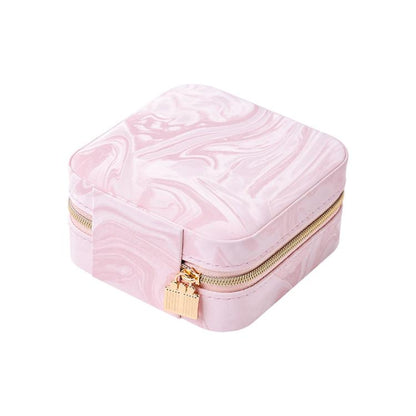 Pink travel jewelry organizer pouch with water-ripple velvet texture and gold zipper.