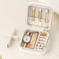 White travel jewelry organizer pouch open with jewelry slots and fitted divider insert.
