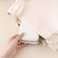 Light pink travel jewelry organizer pouch with drawstring closure and zipper edge.