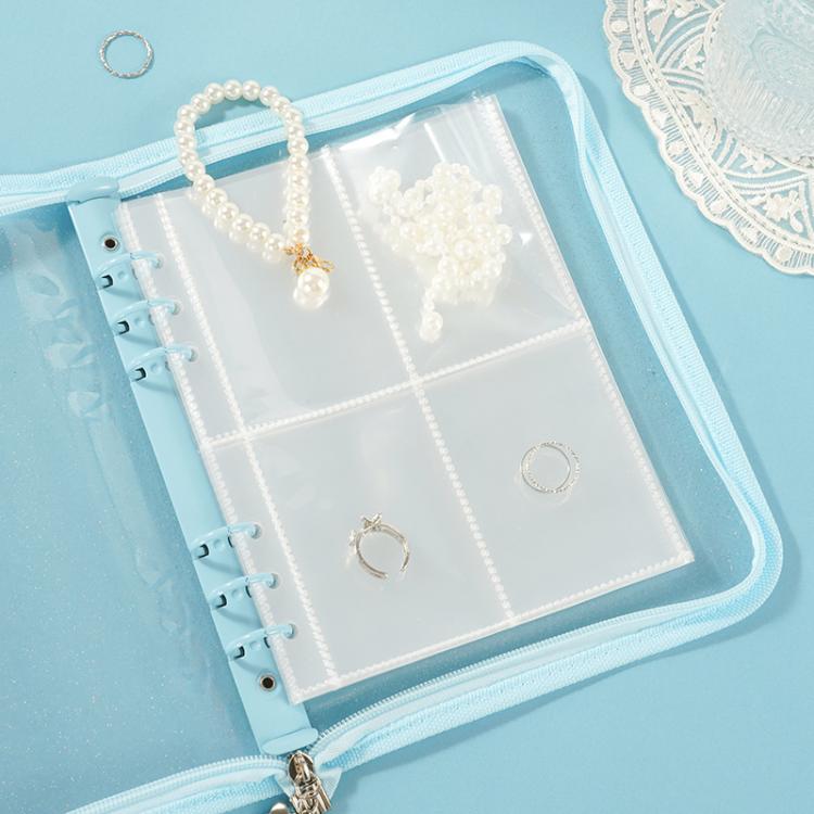 Clear PVC zipper pouch with four-pocket pages holding small jewelry pieces