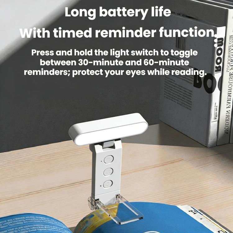 USB rechargeable clip reading lamp with LED folding bookmark on desk, lit.