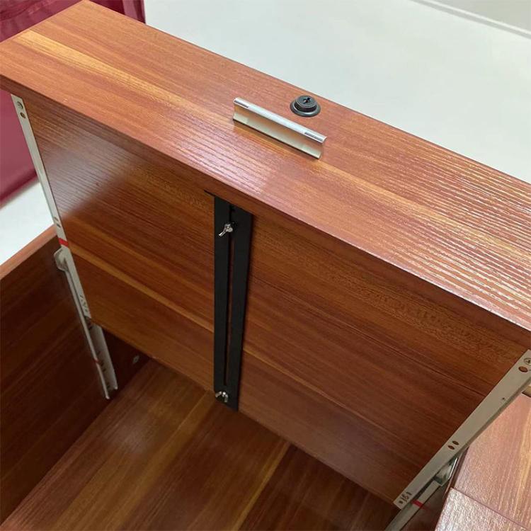 Installed black drawer reinforcement bracket on a wooden drawer cabinet