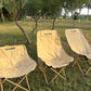 Portable folding moon chairs with light beige protective covers and bronze legs