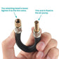 Hand holding bicycle pump extension hose with threaded copper valve connector
