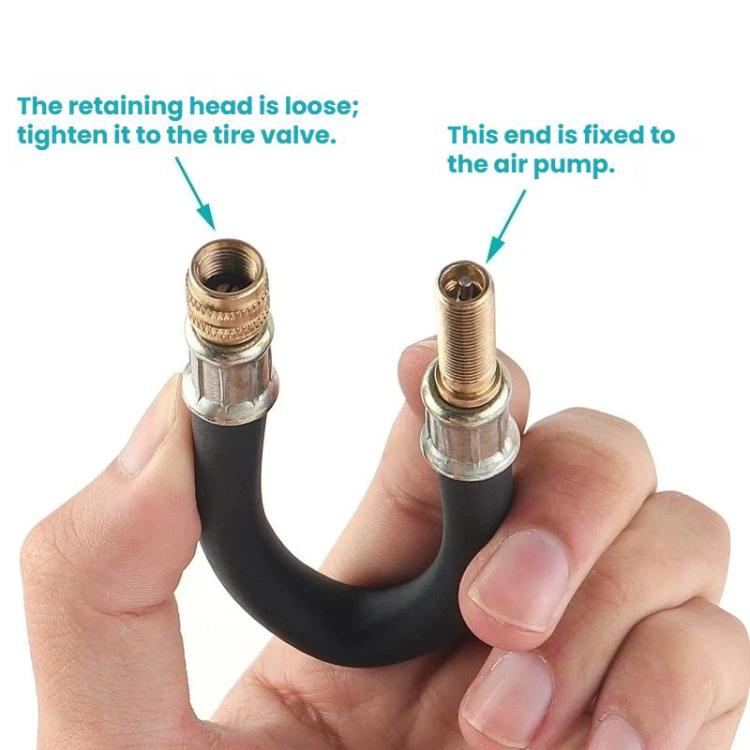 Hand holding bicycle pump extension hose with threaded copper valve connector