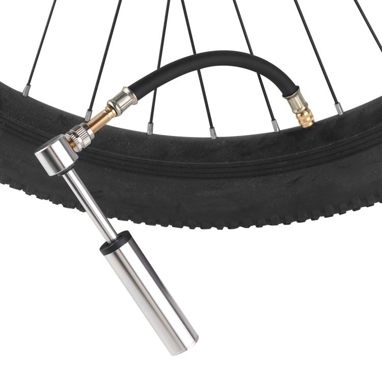 Black bicycle pump extension hose connected to a tire with metal nozzle adapters