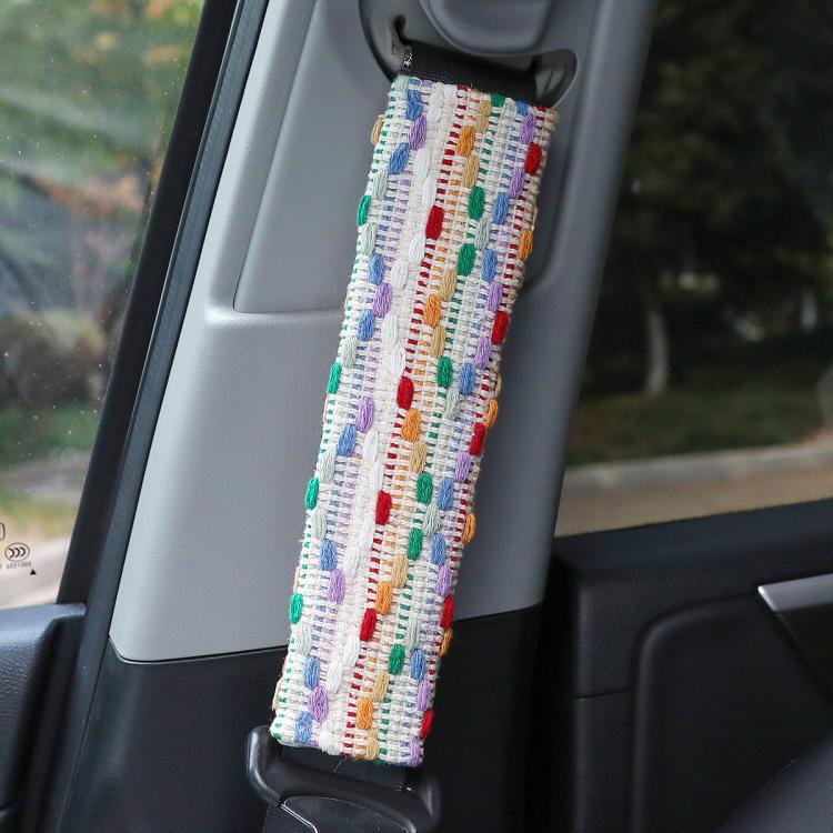 Car seat belt shoulder cover with multicolor dotted woven pattern on white fabric