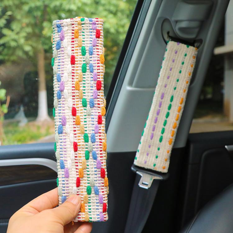 Car seat belt shoulder covers on seats: multicolor and white woven dotted stripes
