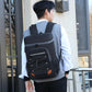 Black insulated backpack cooler with front zip pockets and orange accent panel