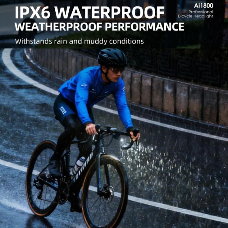 Black bicycle headlight in wet conditions with front lamp glowing
