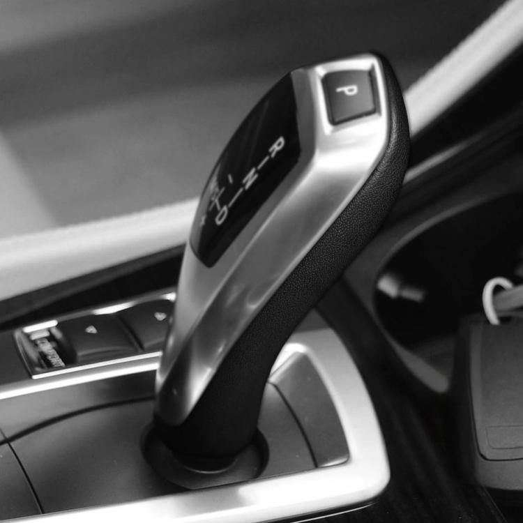 Gear shift knob cover with black texture and silver top with gear icons